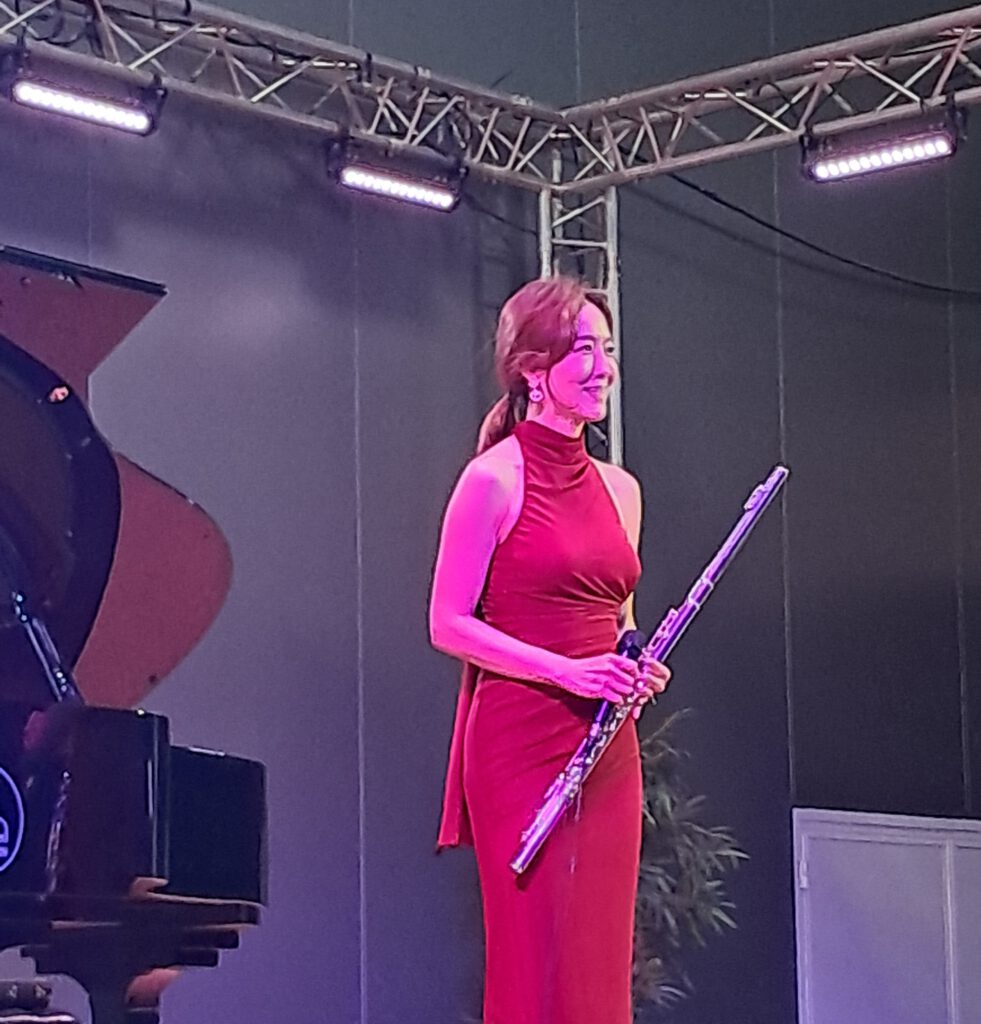 Jasmine Choi on stage, with flute
